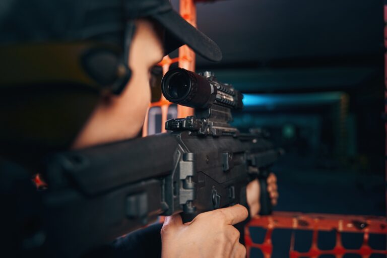 Experienced woman sniper firing an assault rifle
