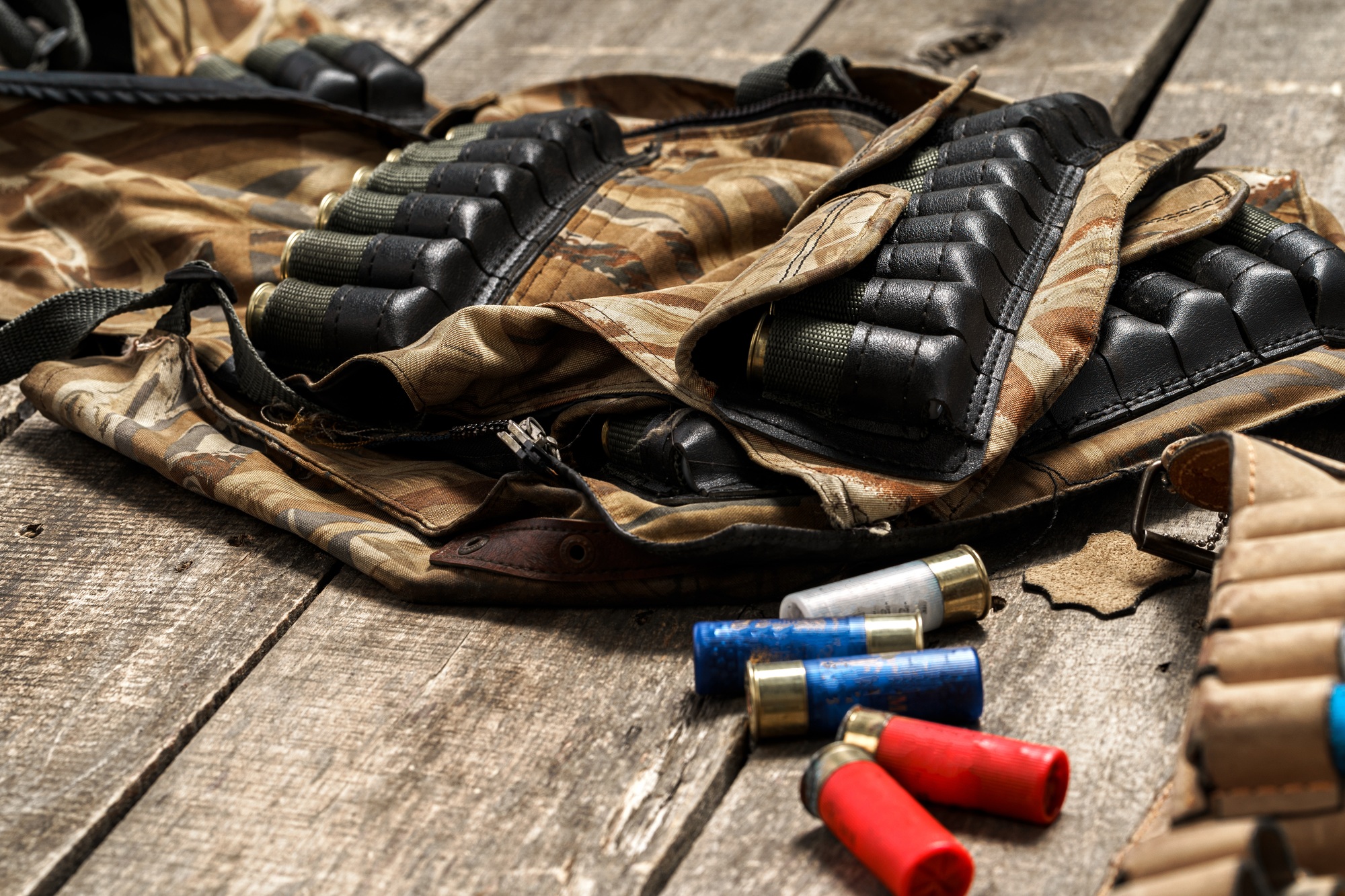 Various hunting equipment on old wooden background